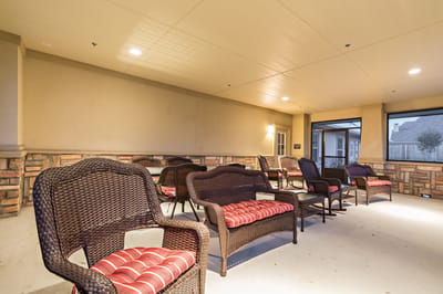 Outdoor seating area with wicker chairs and cushions