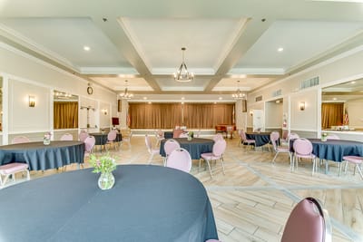 Interior view of a community event space with tables and chairs