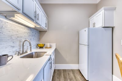 A modern kitchen area with appliances and cabinetry