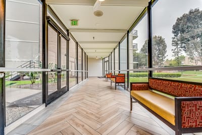 Bright hallway with seating and large windows