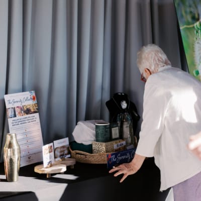 A resident examining decor items at an event table