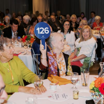 Residents participating in an engaging activity at a dining table