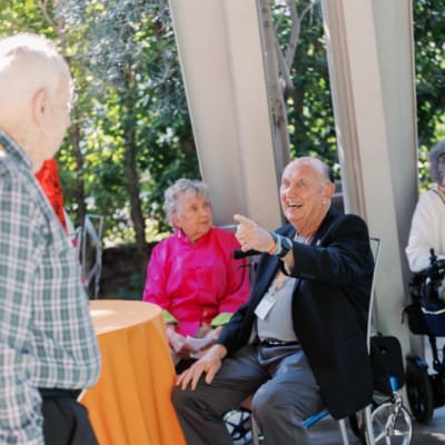 Residents enjoying conversation at an outdoor gathering