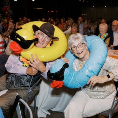 Resident couple enjoying a themed party with inflatable pool rings