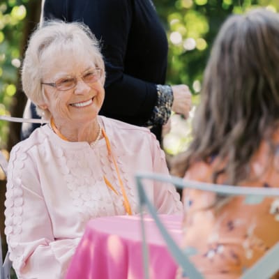 A smiling resident enjoying conversation outdoors