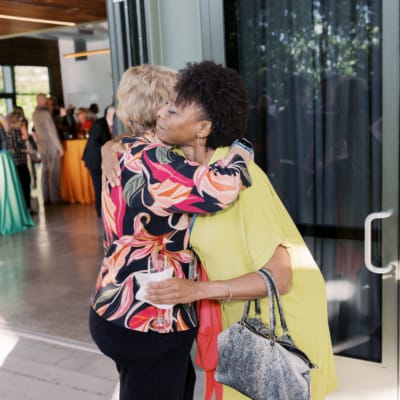 Two women embracing at a social gathering