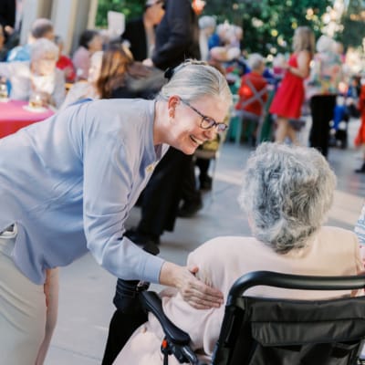 A staff member engaging with a resident at an activity event