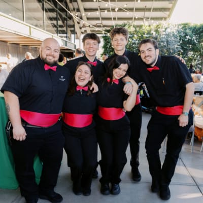 Staff members smiling at a community event