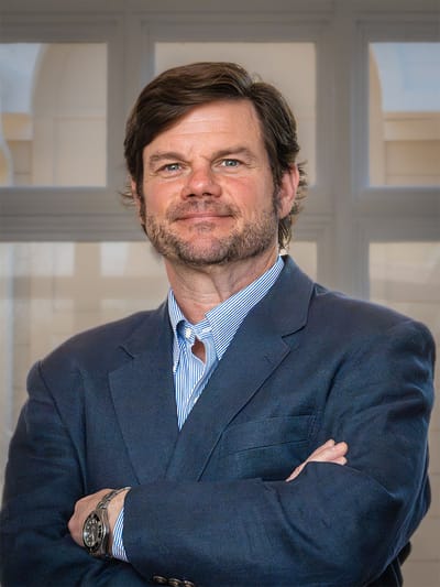 Man in professional attire with arms crossed