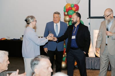 Staff presenting award at a celebratory event