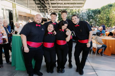 Staff members posing at a community event