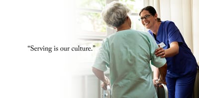 Caregiver interacting with a resident in an interior setting