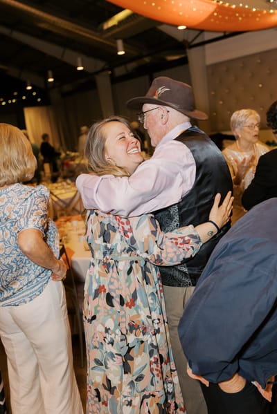 Residents joyfully dancing at a social event