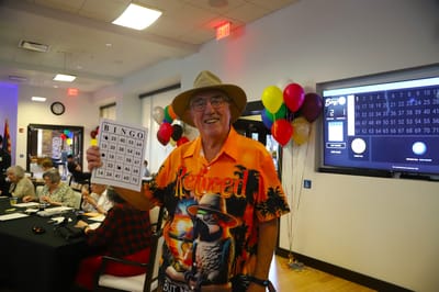 Resident enjoying bingo in a lively activity room