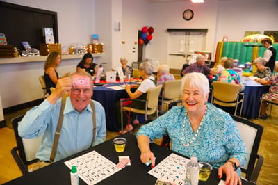 Residents enjoying a bingo game in a common area