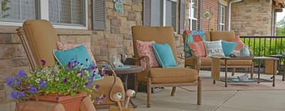 Outdoor seating area with comfortable chairs and flowers