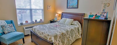 Cozy private resident room with bed and decor