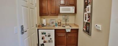 Kitchenette area with cabinets and microwave