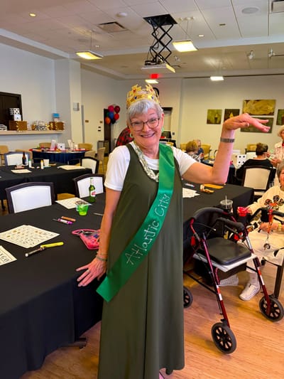 Resident dressed for a celebration in a common area