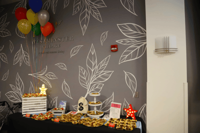 Table display with snacks and colorful balloons in a common area