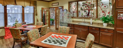 Brightly decorated common area with games and plants