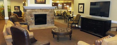 Common area with seating and fireplace in the facility