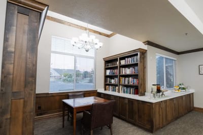 Cozy reading area with bookshelves and a table.