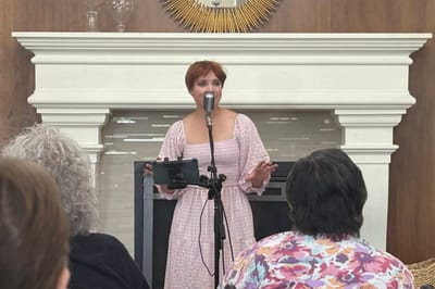 A performer engaging with residents in a common area.