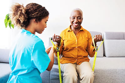 Senior woman exercising with a caregiver