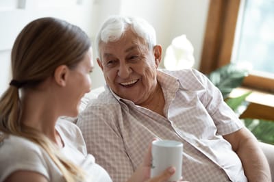 Senior man enjoying conversation with caregiver