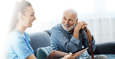 Senior resident engaging with staff member.