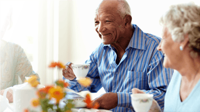Senior residents enjoying tea in a common area.