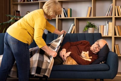 Senior resident being covered with a blanket