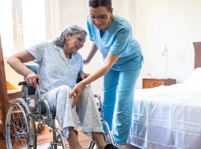 Caregiver assisting a resident in a room