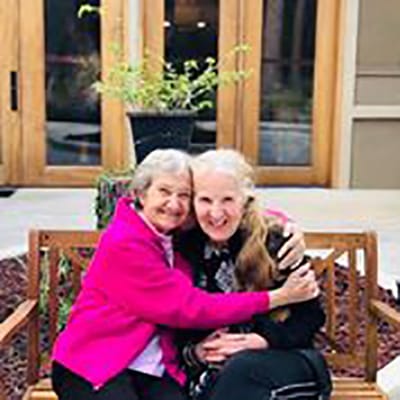 Two residents enjoying time together outdoors.