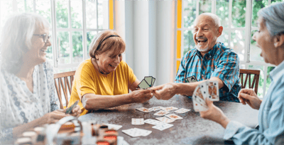 Seniors playing cards together at a table