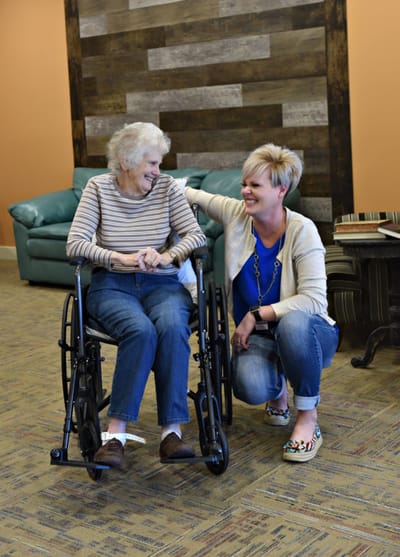 Care staff interacting joyfully with a resident.