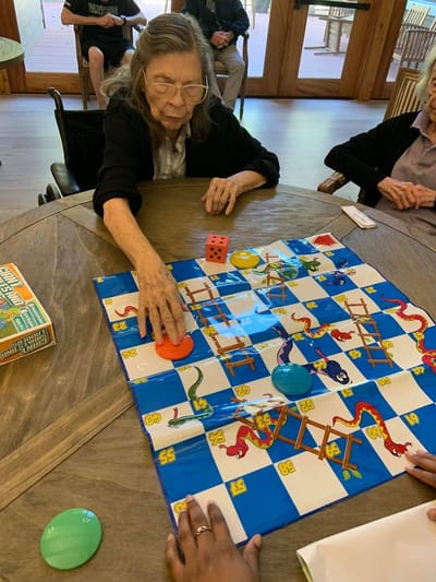 Residents playing a board game together