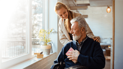 Caregiver assisting an elderly resident indoors