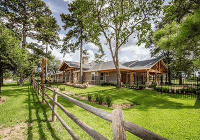Building exterior surrounded by trees and grass