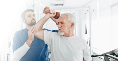 Senior man exercising with professional assistance