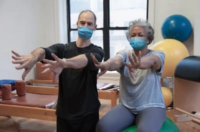 Two participants engaging in physical therapy exercise