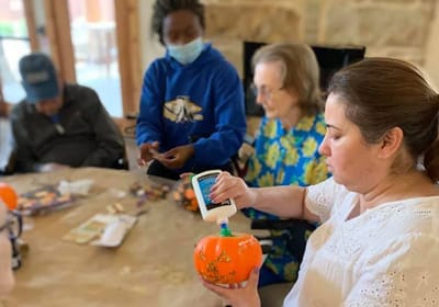 Residents and staff engaged in a crafting activity.