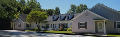 Exterior view of a senior living facility with landscaped garden