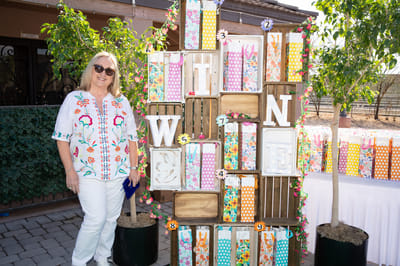 A woman standing next to a colorful decor installation