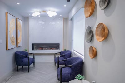 Cozy common area with comfortable chairs and a fireplace