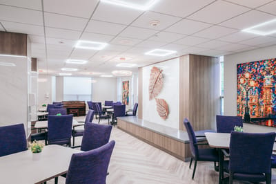 Bright common area with purple chairs and decorative wall art