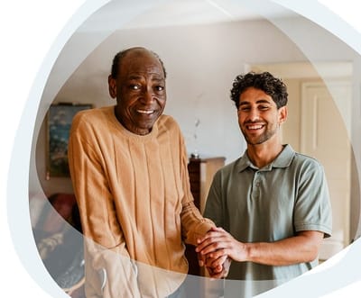 Gentiva Hospice – Tucson, home care in Tucson, AZ — Senior caregiver assisting elderly man with a warm smile