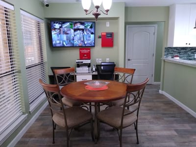 Common area with a table and wall-mounted monitors
