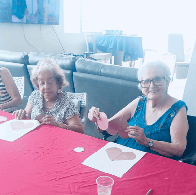 Residents engaged in an art activity at a common table